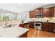 Kitchen with stainless steel appliances, granite countertops, and rich wooden cabinets at 1034 Ventnor Pl, Cary, NC 27519