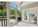 Screened-in porch with wood floors and serene views of surrounding greenery at 1034 Ventnor Pl, Cary, NC 27519