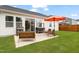 Beautiful backyard with a patio, outdoor furniture, grill and a well-manicured lawn at 1109 Briar Gate Dr, Holly Springs, NC 27540