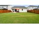 Lush backyard with a patio, furniture, an orange umbrella, and a privacy fence at 1109 Briar Gate Dr, Holly Springs, NC 27540
