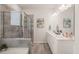 A modern bathroom features a dual sink vanity, shower and a separate soaking tub at 1109 Briar Gate Dr, Holly Springs, NC 27540