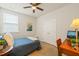 A small bedroom features a ceiling fan, carpet, and natural light at 1109 Briar Gate Dr, Holly Springs, NC 27540