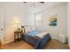 A simple bedroom features a ceiling fan, carpet, and natural light at 1109 Briar Gate Dr, Holly Springs, NC 27540