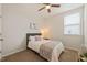 Cozy bedroom featuring a ceiling fan and a window with bright natural light at 1109 Briar Gate Dr, Holly Springs, NC 27540