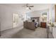 A spacious bedroom with a ceiling fan, carpet, natural light, and an ensuite bath at 1109 Briar Gate Dr, Holly Springs, NC 27540