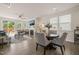 Open-concept dining area with hardwood floors and views of the living room and patio at 1109 Briar Gate Dr, Holly Springs, NC 27540