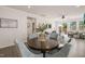 Open-concept dining area with hardwood floors, table and views of the living room and patio at 1109 Briar Gate Dr, Holly Springs, NC 27540
