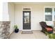 Inviting front porch with cozy seating and a beautifully detailed front door at 1109 Briar Gate Dr, Holly Springs, NC 27540