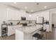 Modern kitchen with granite countertops, stainless steel appliances, and a center island with bar stool seating at 1109 Briar Gate Dr, Holly Springs, NC 27540