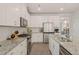 Modern kitchen with granite countertops, stainless steel appliances, and white cabinetry at 1109 Briar Gate Dr, Holly Springs, NC 27540