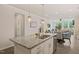 Open-concept kitchen featuring granite countertops, island and views of the dining and living areas at 1109 Briar Gate Dr, Holly Springs, NC 27540