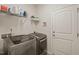 Convenient laundry room with modern washer and dryer units and ample storage space at 1109 Briar Gate Dr, Holly Springs, NC 27540