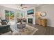 Cozy living room featuring fireplace, tv, hardwood floors and comfortable seating at 1109 Briar Gate Dr, Holly Springs, NC 27540