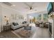 Bright living room featuring hardwood floors, neutral decor, and a sliding glass door to patio at 1109 Briar Gate Dr, Holly Springs, NC 27540