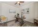 Home office features wood-look floors, a ceiling fan, natural light, and neutral paint at 1109 Briar Gate Dr, Holly Springs, NC 27540
