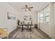 A home office features a ceiling fan, a window with natural light, and a wooden desk and chair at 1109 Briar Gate Dr, Holly Springs, NC 27540