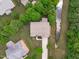 An aerial view of a well maintained home, surrounded by mature trees and green lawn with a stream running adjacent at 111 Revere Forest Ct, Cary, NC 27519