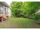 Spacious backyard with greenery and access to the screened in porch at 111 Revere Forest Ct, Cary, NC 27519