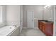 Bathroom with a soaking tub, granite countertops, and tile flooring at 111 Revere Forest Ct, Cary, NC 27519