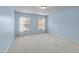 Spacious bedroom featuring carpeted floors and two bright windows at 111 Revere Forest Ct, Cary, NC 27519