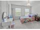 Bright bedroom with two windows, chandelier, and carpeted floors at 111 Revere Forest Ct, Cary, NC 27519