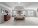 Spacious bedroom with tray ceiling, natural light, and comfortable furniture at 111 Revere Forest Ct, Cary, NC 27519