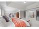 Bright bedroom shows plenty of space with an open doorway to a hallway and stairway at 111 Revere Forest Ct, Cary, NC 27519