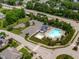 Aerial view of a sparkling community pool with ample parking, play area, and lush landscaping at 111 Revere Forest Ct, Cary, NC 27519