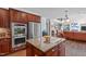 Gourmet kitchen with hardwood floors, island, and stainless appliances at 111 Revere Forest Ct, Cary, NC 27519