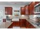 Kitchen with stainless appliances, hardwood floors, and granite counters at 111 Revere Forest Ct, Cary, NC 27519