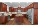 Kitchen with stainless appliances, hardwood floors, and dark wood cabinetry at 111 Revere Forest Ct, Cary, NC 27519