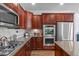 Kitchen with granite counters, hardwood floors, and stainless appliances at 111 Revere Forest Ct, Cary, NC 27519
