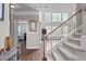 Inviting living room showcasing the staircase and an open view into multiple rooms, creating an open and airy feel at 111 Revere Forest Ct, Cary, NC 27519