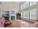 Bright living room featuring hardwood floors, fireplace, and large windows at 111 Revere Forest Ct, Cary, NC 27519