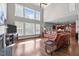 Bright living room with large windows, hardwood floors, and comfortable seating, perfect for relaxation and entertainment at 111 Revere Forest Ct, Cary, NC 27519