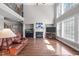 Spacious living room with a fireplace, large windows, and hardwood flooring at 111 Revere Forest Ct, Cary, NC 27519