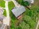 Aerial view of a home with a well-maintained lawn, patio, and mature trees at 1111 Barrow Nook Ct, Apex, NC 27502