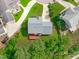 Aerial view of a home with a well-maintained lawn, patio, and mature trees at 1111 Barrow Nook Ct, Apex, NC 27502