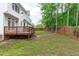 Spacious backyard with a wooden deck, lawn, and fencing at 1111 Barrow Nook Ct, Apex, NC 27502
