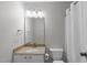 Bright bathroom with granite countertop, white cabinets, toilet and shower with curtain at 1111 Barrow Nook Ct, Apex, NC 27502