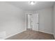 An empty bedroom with neutral walls and carpet features a single door closet at 1111 Barrow Nook Ct, Apex, NC 27502