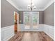 Elegant dining room featuring hardwood floors and french doors at 1111 Barrow Nook Ct, Apex, NC 27502