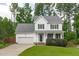 Charming two-story home featuring a well-manicured lawn and an attached two-car garage at 1111 Barrow Nook Ct, Apex, NC 27502