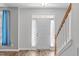 Inviting foyer with staircase and decorative window above a solid white front door at 1111 Barrow Nook Ct, Apex, NC 27502