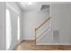 Inviting foyer with staircase and hardwood flooring at 1111 Barrow Nook Ct, Apex, NC 27502