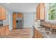 Well-lit kitchen featuring stainless steel appliances, granite countertops, and wood-look floors at 1111 Barrow Nook Ct, Apex, NC 27502