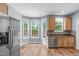 Bright kitchen featuring a bay window, stainless steel appliances, and wood-look floors at 1111 Barrow Nook Ct, Apex, NC 27502