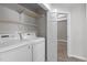 Laundry room with shelving, LG washer and dryer and entrance to another room at 1111 Barrow Nook Ct, Apex, NC 27502
