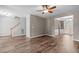Living room featuring hardwood floors, fireplace and ceiling fan at 1111 Barrow Nook Ct, Apex, NC 27502