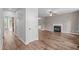 Open-concept living room featuring hardwood floors and a fireplace at 1111 Barrow Nook Ct, Apex, NC 27502
